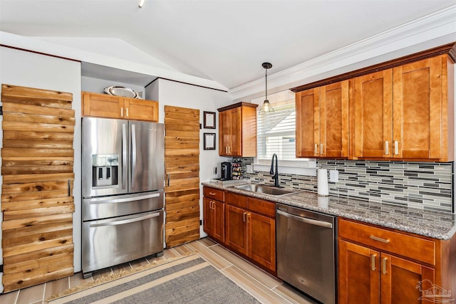 kitchen with stainless steel appliances, decorative backsplash, lofted ceiling, dark stone counters, and sink