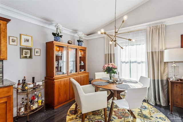 dining room with dark hardwood / wood-style flooring, ornamental molding, a notable chandelier, and vaulted ceiling