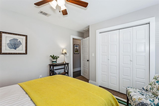 carpeted bedroom with ceiling fan and a closet