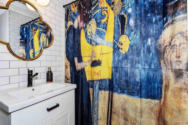 bathroom featuring tasteful backsplash, vanity, and tile walls