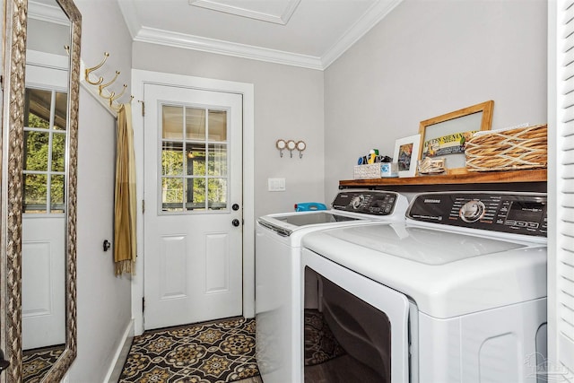 laundry room featuring a healthy amount of sunlight, washer and clothes dryer, and crown molding