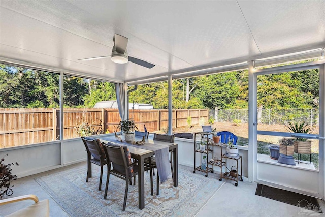 sunroom featuring ceiling fan and a healthy amount of sunlight