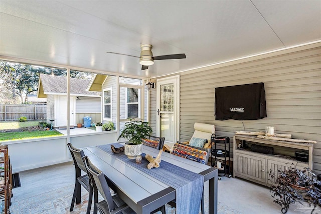 sunroom featuring ceiling fan