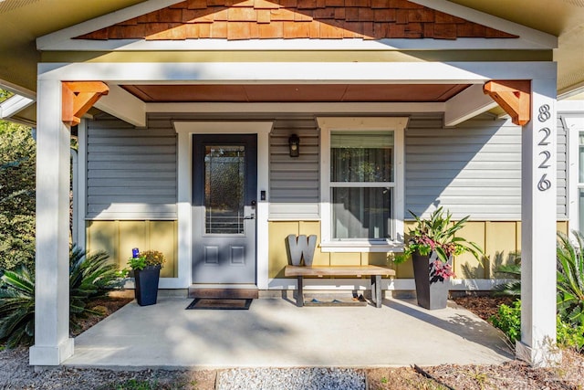 view of exterior entry with covered porch