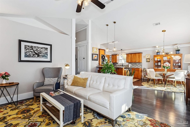 living room featuring ceiling fan with notable chandelier, sink, dark hardwood / wood-style floors, and lofted ceiling