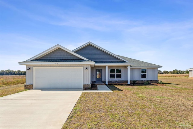 craftsman-style house with an attached garage, a front lawn, board and batten siding, and concrete driveway