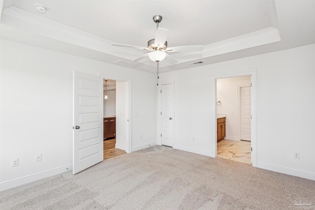unfurnished bedroom with visible vents, baseboards, light carpet, and connected bathroom