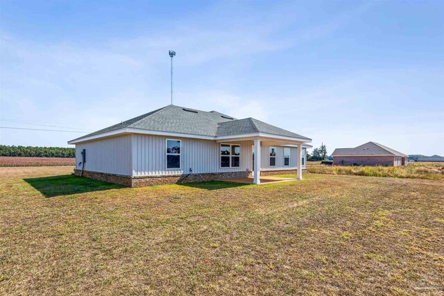 back of house with a yard and a patio area