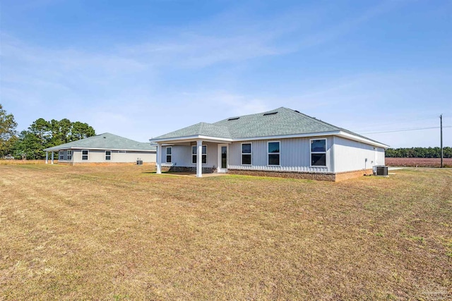 9319 Salter Rd, Pace, FL 32571 - back of house with a lawn, a shingled roof, and central AC