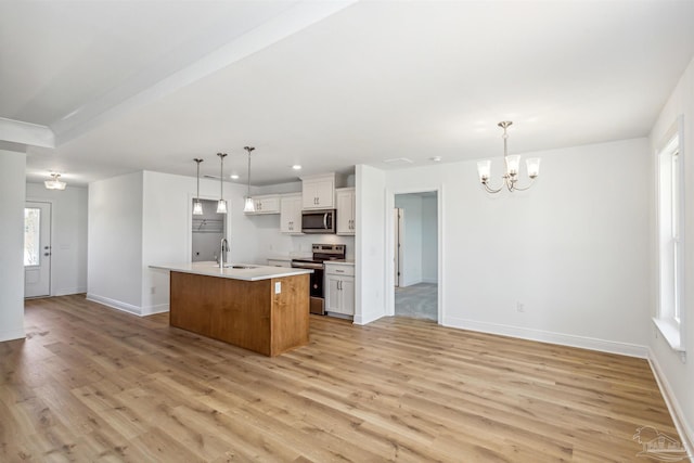 9319 Salter Rd, Pace, FL 32571 - kitchen with a sink, stainless steel appliances, and light wood finished floors