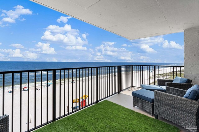 balcony featuring a water view and a view of the beach