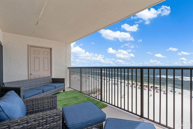 balcony with a water view and a beach view