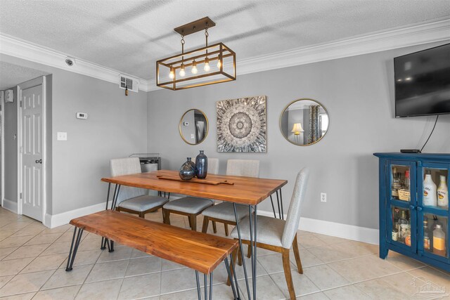 dining space with ornamental molding, a textured ceiling, and light tile patterned flooring