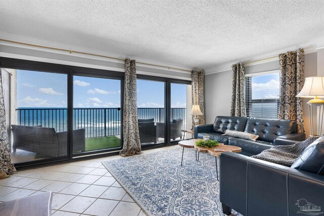 tiled living room with a water view, crown molding, and a textured ceiling