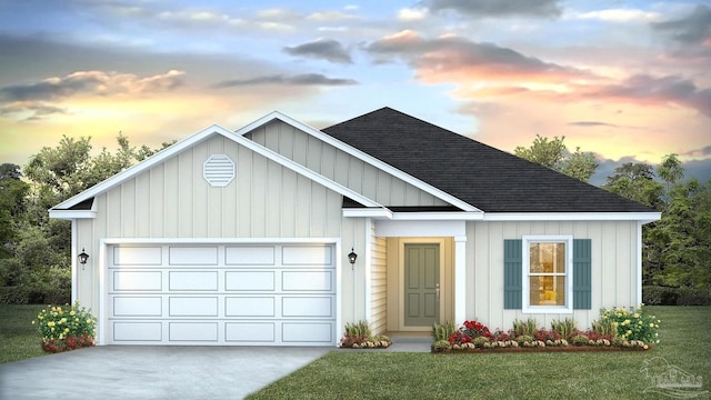 view of front of property with a yard and a garage