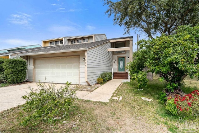 view of front of property featuring a garage and concrete driveway