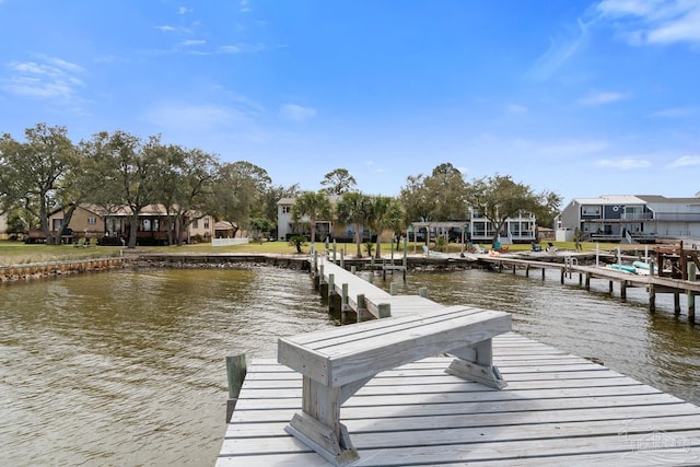 dock area featuring a water view and a residential view