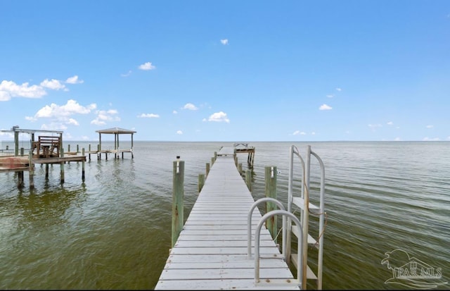 dock area with a water view and boat lift