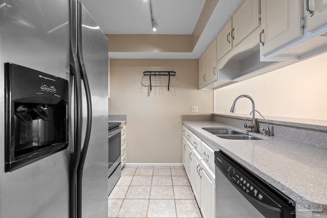 kitchen with light tile patterned floors, a sink, baseboards, appliances with stainless steel finishes, and track lighting