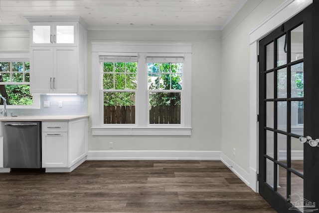 kitchen featuring white cabinetry, decorative backsplash, stainless steel dishwasher, crown molding, and wooden ceiling