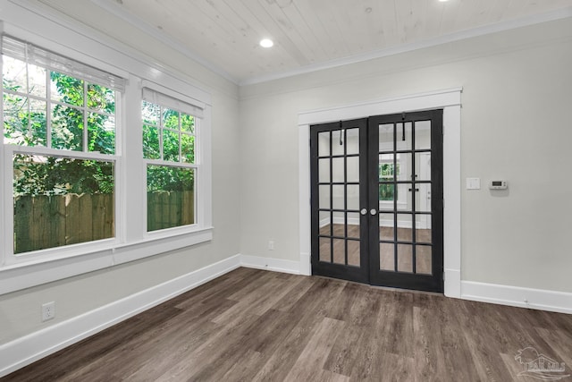 spare room featuring french doors, ornamental molding, hardwood / wood-style floors, and wooden ceiling