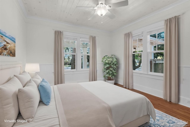 bedroom with hardwood / wood-style floors, wood ceiling, ornamental molding, and ceiling fan