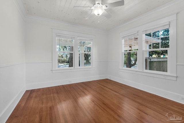 empty room with crown molding, wood-type flooring, wooden ceiling, and ceiling fan