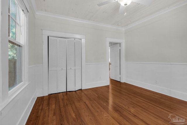 unfurnished bedroom with wood ceiling, ceiling fan, wood-type flooring, ornamental molding, and a closet