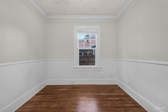 spare room featuring dark wood-type flooring, wood ceiling, and ornamental molding