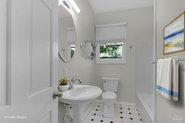 bathroom with toilet, sink, and a bath