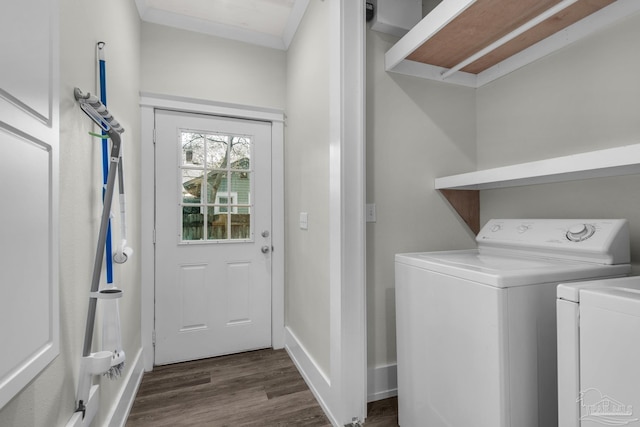 washroom with dark hardwood / wood-style flooring and washing machine and dryer