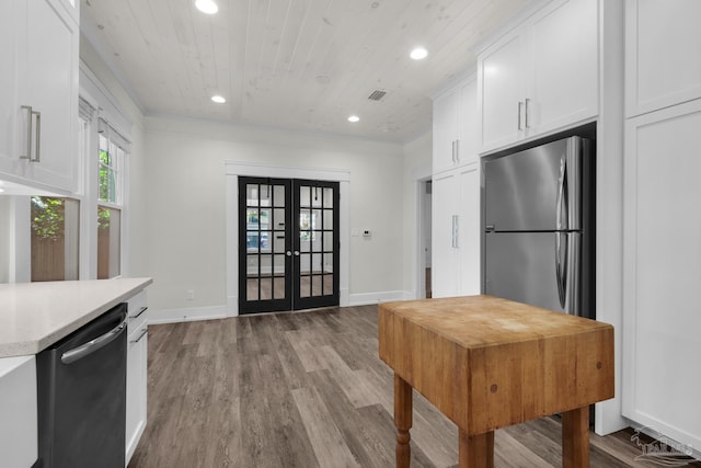 kitchen with white cabinetry, wood ceiling, stainless steel appliances, light wood-type flooring, and french doors