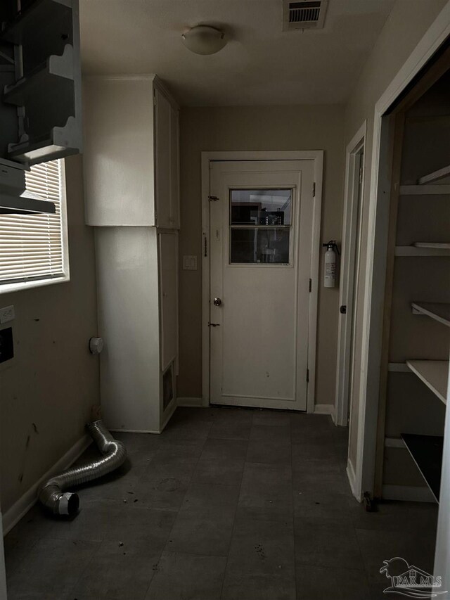 hall with tile patterned flooring