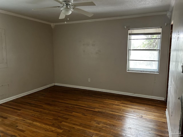 spare room with ceiling fan, a textured ceiling, dark wood-style flooring, baseboards, and ornamental molding