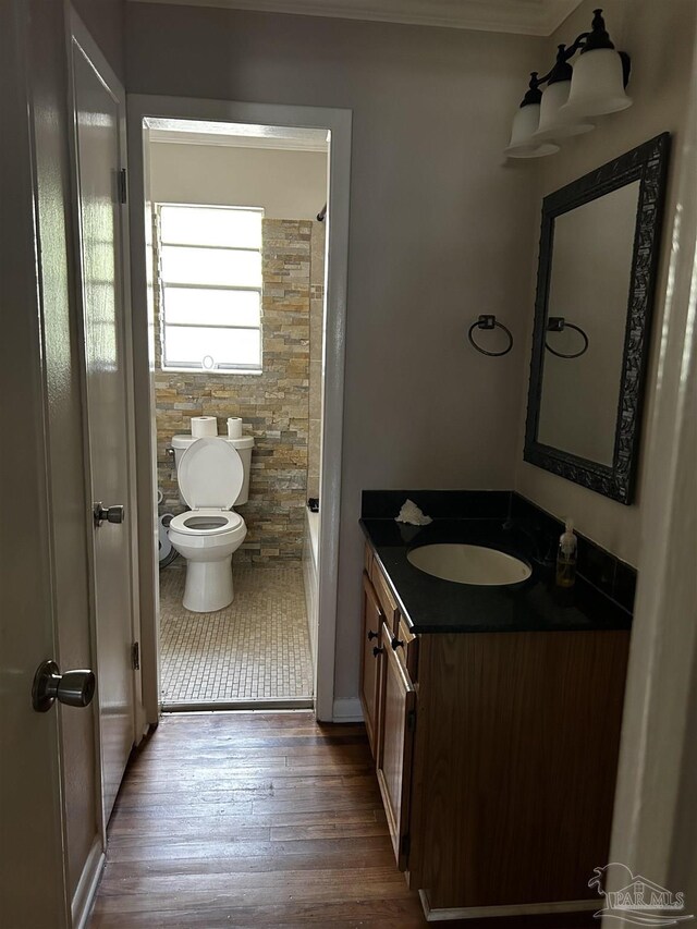 full bathroom with shower / bathtub combination, vanity, hardwood / wood-style flooring, and toilet