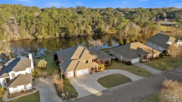 drone / aerial view with a water view and a view of trees