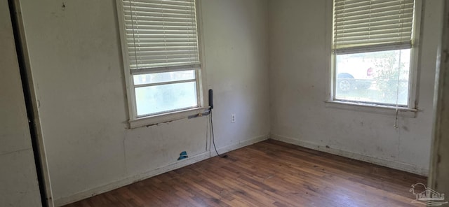 spare room featuring wood finished floors