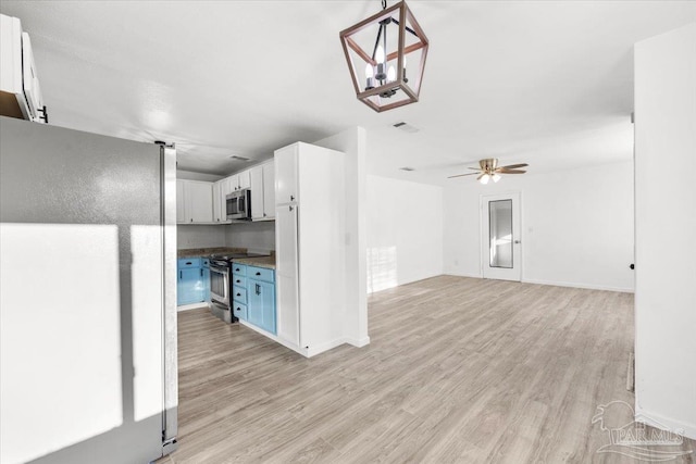 kitchen featuring visible vents, light wood-style flooring, ceiling fan, white cabinets, and appliances with stainless steel finishes