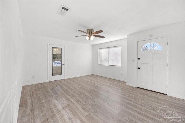 foyer featuring visible vents, baseboards, and light wood-style flooring