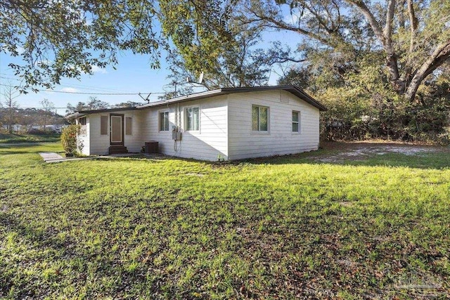 exterior space with a yard and central AC