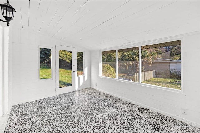 unfurnished sunroom with lofted ceiling and wood ceiling