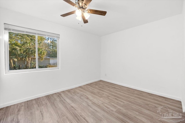 unfurnished room featuring wood finished floors, baseboards, and ceiling fan