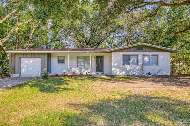 ranch-style home with a garage, a porch, and a front lawn