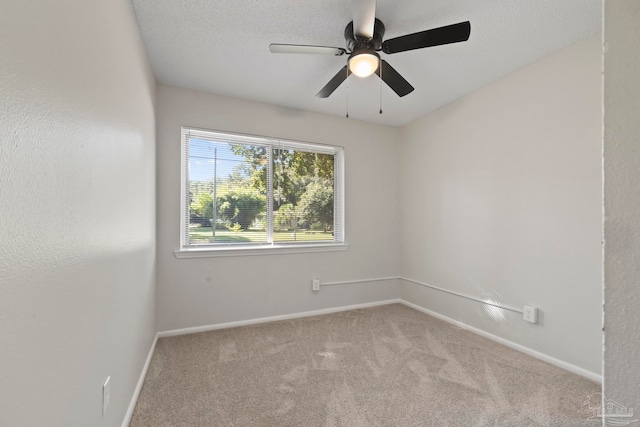 carpeted empty room featuring a textured ceiling and ceiling fan