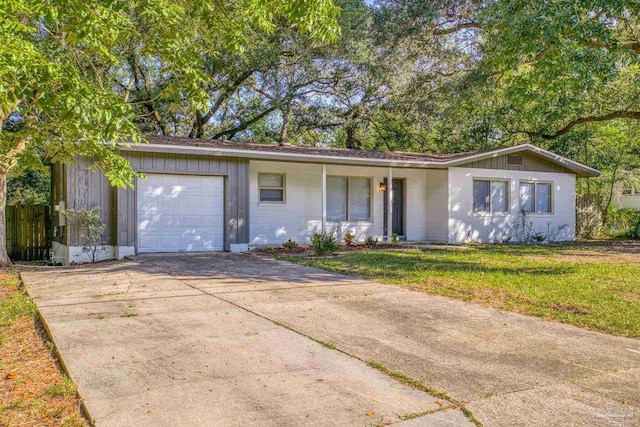 ranch-style home featuring a garage and a front lawn