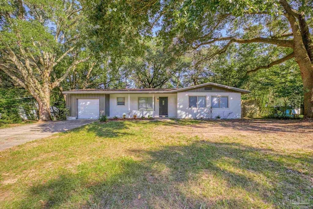 single story home featuring a front yard and a garage