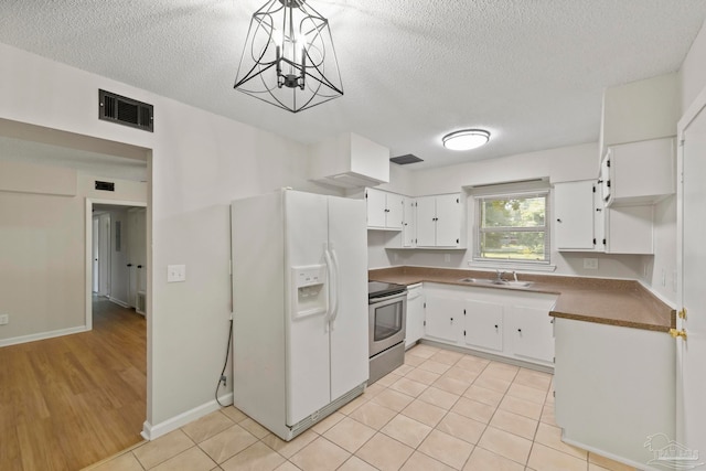 kitchen with white refrigerator with ice dispenser, sink, white cabinetry, decorative light fixtures, and stainless steel electric range