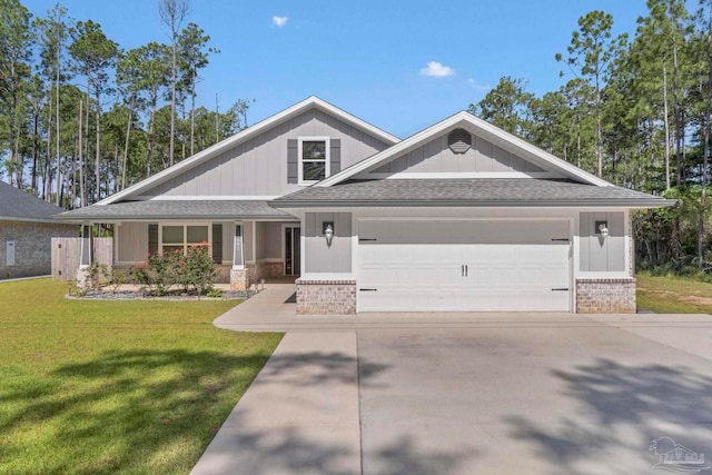 591 Nowak Rd, Cantonment, FL 32533 - craftsman house featuring brick siding, a garage, a front lawn, and board and batten siding