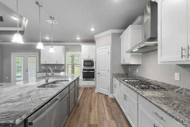 591 Nowak Rd, Cantonment, FL 32533 - kitchen featuring stainless steel appliances, a sink, wall chimney range hood, white cabinets, and recessed lighting