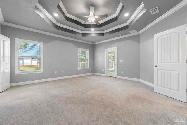 591 Nowak Rd, Cantonment, FL 32533 - empty room with crown molding, carpet flooring, a ceiling fan, a raised ceiling, and baseboards